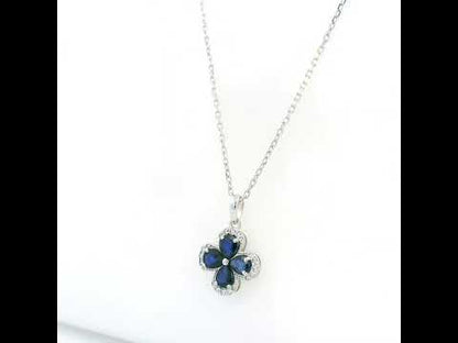 Blue sapphire and diamond floral pendant in 18K white gold featuring four pear-shaped sapphires with diamond surrounds by Emirates Diamonds.