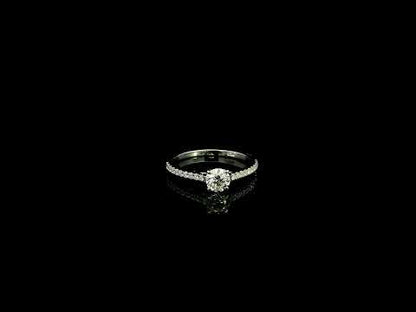 18K white gold round brilliant diamond solitaire engagement ring featuring a 0.51 carat GIA certified natural diamond with a pavé diamond band.