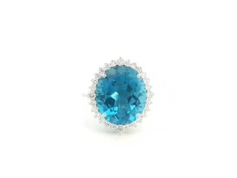 9.81 carat oval London Blue Topaz halo ring with natural diamonds in 18K white gold.