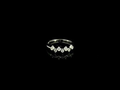 18K white gold diamond stack ring featuring natural round brilliant diamonds totaling 0.23 carat in a flowing shared prong design.