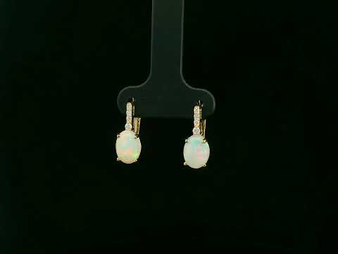 Oval opal and diamond drop earrings in 18K yellow gold by Emirates Diamonds.