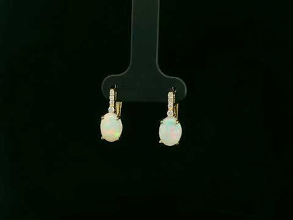 Oval opal and diamond drop earrings in 18K yellow gold by Emirates Diamonds.