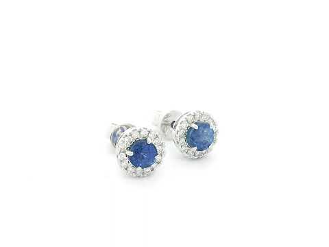 18K white gold sapphire halo stud earrings featuring 1.06 carats of blue sapphires surrounded by 0.16 carats of natural diamonds.