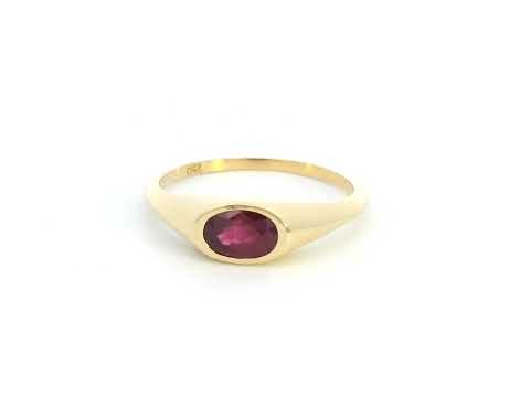 18K yellow gold ring with a 0.75-carat oval-shaped ruby in a classic bezel setting.