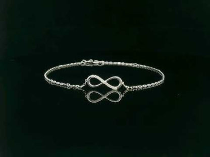 18K white gold infinity bracelet with 0.05 carat diamonds on delicate chain, half polished and half pavé-set