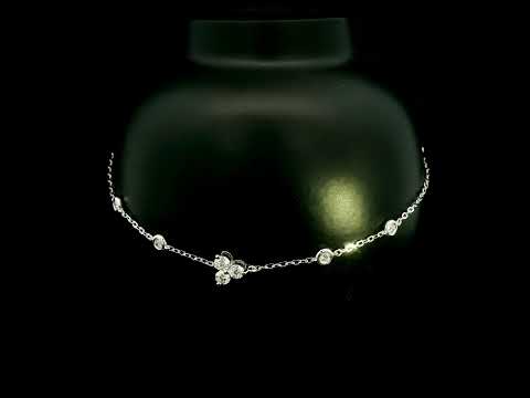 18K white gold diamond station bracelet featuring a central three-diamond cluster and four bezel-set round diamond stations along a delicate chain.