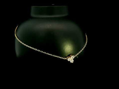 18K yellow gold diamond cluster bracelet featuring three round diamonds in a central prong setting on a delicate gold chain.