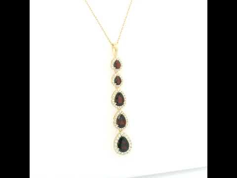18K yellow gold garnet and diamond drop pendant featuring five pear shaped red garnets totalling 2.26 carats, each surrounded by a halo of round diamonds totalling 0.36 carat. Chain not included.