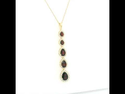 18K yellow gold garnet and diamond drop pendant featuring five pear shaped red garnets totalling 2.26 carats, each surrounded by a halo of round diamonds totalling 0.36 carat. Chain not included.