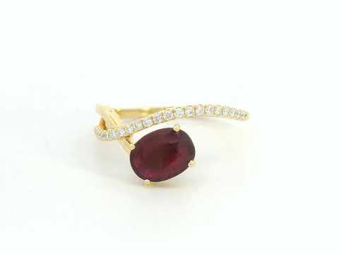 18K yellow gold oval ruby bypass ring with round diamond accents, modern luxury design