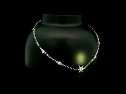Diamond chain bracelet in 18K white gold featuring a pavé diamond star motif with bezel-set station diamonds totalling 0.16 carat.