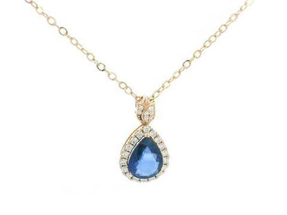 Blue sapphire pendant with diamond halo and tulip bail in 18K rose gold