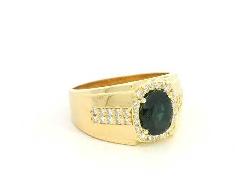 Men’s blue sapphire and diamond ring in 18K yellow gold featuring a 1.93 carat oval sapphire with halo and pavé-set side diamonds – Emirates Diamonds