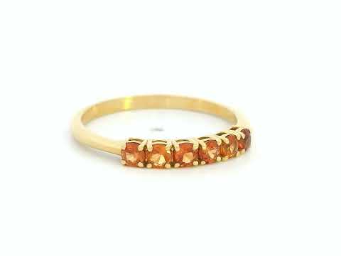 18K yellow gold ring with six round-cut orange sapphires in a half eternity setting

