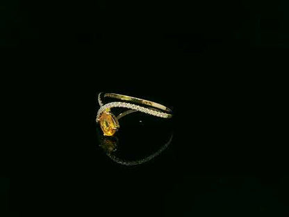 18K yellow gold oval yellow sapphire and diamond bypass statement ring by Emirates Diamonds