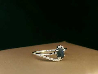 18k white gold ring with 0.63ct oval sapphire & 0.08ct diamond swirl – certificate included
