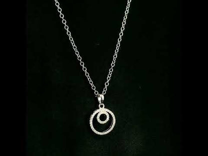 Diamond circle pendant with interlocking open-circle design in 18K white gold, set with round brilliant diamonds.