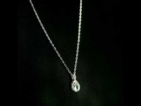 Aquamarine drop pendant necklace in 18K white gold with a round blue aquamarine and delicate diamond accent.