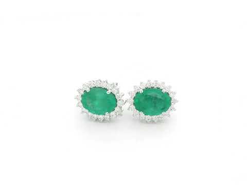 Emerald and diamond halo stud earrings in 18K white gold featuring 2.31 carat emeralds and 0.36 carat diamonds by Emirates Diamonds.
