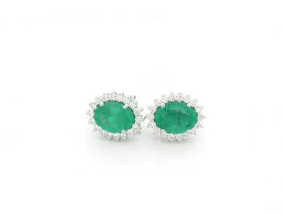 Emerald and diamond halo stud earrings in 18K white gold featuring 2.31 carat emeralds and 0.36 carat diamonds by Emirates Diamonds.