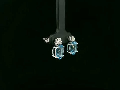 18K white gold stud earrings with oval Swiss Blue Topaz and  diamond accents