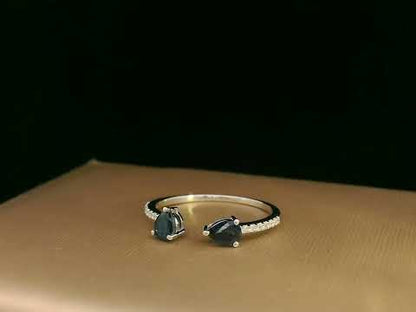 18K white gold open cuff ring with two teardrop-cut blue sapphires (0.70 carat) and 0.10 carat diamond pavé, modern minimalist design