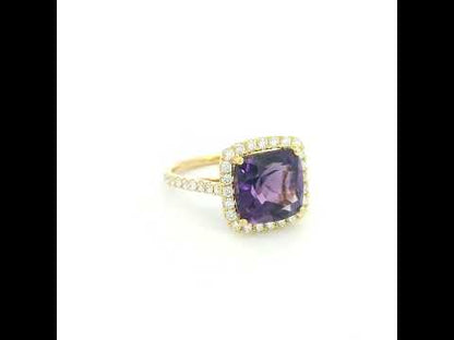 18K yellow gold cushion amethyst and diamond halo ring with purple amethyst, round diamond surround and diamond-set band