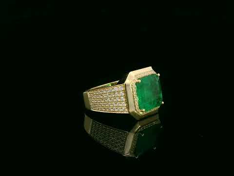 Men’s 18K yellow gold emerald and diamond statement ring featuring a 3.30 carat emerald with diamond halo and wide pavé band by Emirates Diamonds
