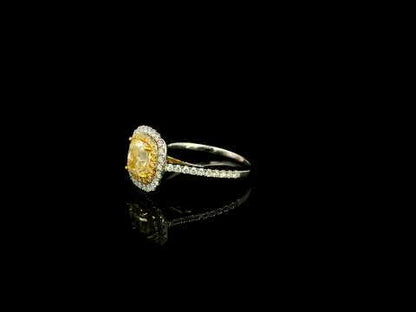 18K white gold engagement ring featuring a 1.50 carat GIA certified natural Fancy Yellow cushion cut diamond surrounded by a yellow diamond inner halo, white diamond outer halo, and diamond pavé band.