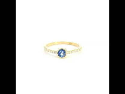 18K yellow gold bezel blue sapphire diamond ring featuring a 0.62 Carat natural round sapphire with diamond-set shoulders.