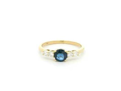 Natural Blue Sapphire and Diamond Ring in 18K Yellow Gold featuring a 0.65 carat round blue sapphire with 0.25 carat natural diamond side stones.