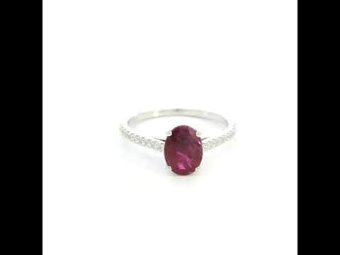 Ruby diamond ring in 18K white gold featuring a natural 1.32 carat oval-cut ruby with a diamond-set band.