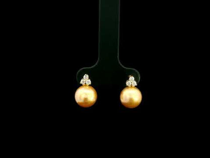 South Sea golden pearl and diamond stud earrings in 18K yellow gold with 8 x 8.5 mm pearls and three-diamond accents