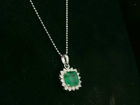 18K white gold emerald and diamond halo pendant by Emirates Diamonds