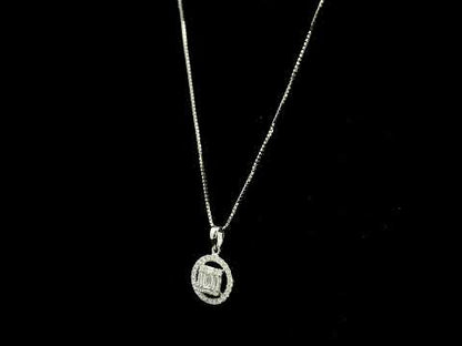 18K white gold diamond pendant featuring round and baguette natural diamonds in an emerald-cut inspired illusion cluster with a sparkling round diamond halo. Chain not included.