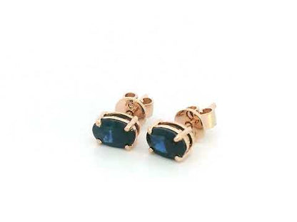 18K rose gold stud earrings with oval-cut natural blue sapphires totaling 1.06 carats, four-prong set with butterfly push backs.