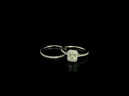 Emerald cut diamond halo bridal set in 18K white gold with a diamond engagement ring and matching wedding band.