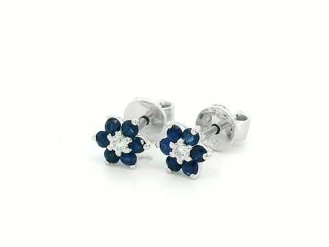 Elegant 18K gold sapphire and diamond flower stud earrings featuring 0.33 carats of blue sapphires and 0.05 carats of diamonds. A timeless floral design.