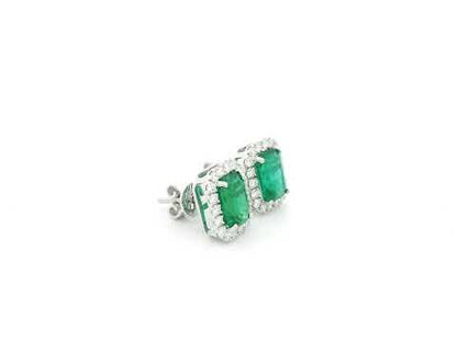 Emerald cut emerald and diamond halo stud earrings in 18K white gold Emirates Diamonds