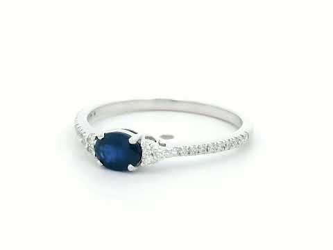 18K white gold sapphire and diamond ring featuring a 0.46-carat oval blue sapphire with 0.15 carats of sparkling diamonds on a delicate band.