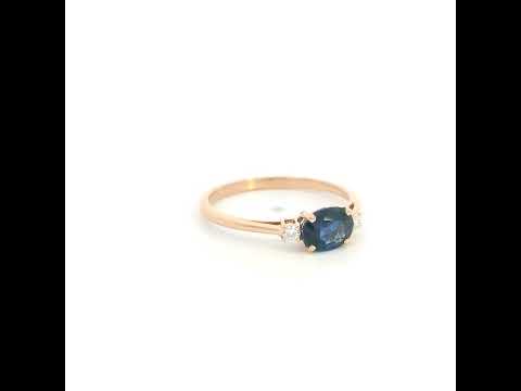18K rose gold oval blue sapphire ring featuring a 1.06 Carat natural sapphire with round natural diamond side stones.
