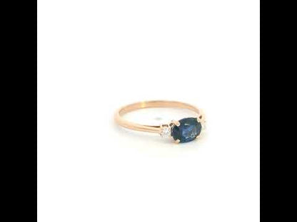18K rose gold oval blue sapphire ring featuring a 1.06 Carat natural sapphire with round natural diamond side stones.