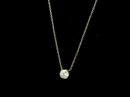 18K yellow gold solitaire necklace featuring a 1.01 carat GIA certified round brilliant natural diamond in a classic four-prong setting.