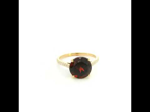 Garnet diamond ring in 18K yellow gold featuring a natural 4.59 carat round-cut garnet with a diamond-set band.