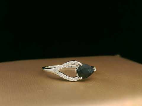 18K white gold asymmetrical ring with 0.78 carat pear-shaped blue sapphire and pavé diamonds, elegant contemporary design