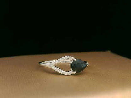 18K white gold asymmetrical ring with 0.78 carat pear-shaped blue sapphire and pavé diamonds, elegant contemporary design