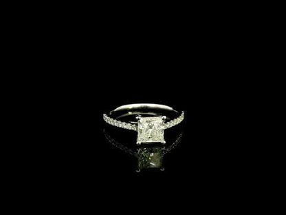 18K white gold engagement ring featuring a 1.50 carat IGI certified natural princess cut diamond with G color and SI2 clarity, accented by 0.20 carat natural round brilliant diamonds on the band.