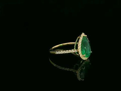 18K yellow gold pear-shaped emerald and diamond halo ring with 2.69 carat emerald and 0.40 carat total diamond weight by Emirates Diamonds