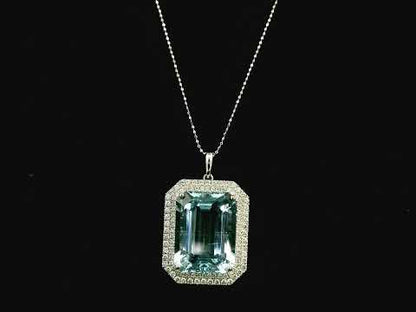 Emerald-cut aquamarine and diamond halo pendant in 18K white gold with large natural aquamarine center stone