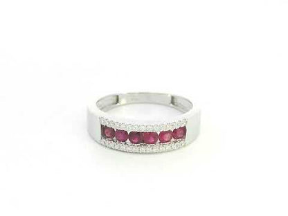 Ruby and diamond channel set ring in 18K white gold featuring 0.51 carat natural rubies and 0.12 carat diamonds